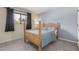 Cozy bedroom with wood-framed bed and neutral colored carpet at 2524 S El Paradiso -- # 106, Mesa, AZ 85202