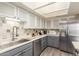 Modern kitchen with gray cabinets, stainless steel appliances, and tile backsplash at 2524 S El Paradiso -- # 106, Mesa, AZ 85202