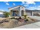 Single-story home with landscaped front yard, two-car garage, and inviting porch at 26330 W Kimberly Way, Buckeye, AZ 85396