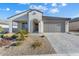 New construction home with attractive curb appeal and desert landscaping at 26330 W Kimberly Way, Buckeye, AZ 85396