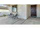 Small front porch with metal chairs and a small table at 26330 W Kimberly Way, Buckeye, AZ 85396