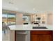 Modern kitchen island with white countertops and stainless steel dishwasher at 26330 W Kimberly Way, Buckeye, AZ 85396