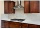 Modern kitchen with stainless steel range hood and herringbone backsplash at 26330 W Kimberly Way, Buckeye, AZ 85396