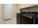 Convenient laundry room with washer, dryer and built-in shelving at 26330 W Kimberly Way, Buckeye, AZ 85396