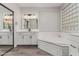 Elegant bathroom with dual vanities, soaking tub, and a subway tile backsplash at 28225 N 65Th Ln, Phoenix, AZ 85083