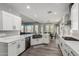 Modern kitchen with white cabinets and a large island at 28225 N 65Th Ln, Phoenix, AZ 85083