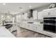 Modern kitchen with white cabinets, large island, and stainless steel appliances at 28225 N 65Th Ln, Phoenix, AZ 85083