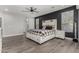 Main bedroom with wood-look floors and access to the en-suite bathroom at 28225 N 65Th Ln, Phoenix, AZ 85083