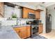 Kitchen features wood cabinets, double sink, and patterned tile backsplash at 2825 N 33Rd Pl, Phoenix, AZ 85008