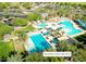 Stunning aerial view of the Mountain Vista Club pool, showcasing its multiple pools, waterslides, and surrounding green spaces at 29798 N 121St Dr, Peoria, AZ 85383