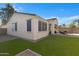 Backyard with manicured synthetic lawn, brick privacy wall, and covered patio with outdoor seating at 29798 N 121St Dr, Peoria, AZ 85383