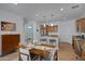 Dining area adjacent to kitchen with wood table at 29798 N 121St Dr, Peoria, AZ 85383