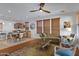 Open living room with hardwood floors, modern furniture and a view into the kitchen at 29798 N 121St Dr, Peoria, AZ 85383