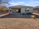 Covered patio and spacious backyard with gravel landscaping at 30734 W Clarendon Ave, Buckeye, AZ 85396