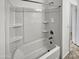 Clean bathroom with a shower/tub combo and built-in shelving at 30734 W Clarendon Ave, Buckeye, AZ 85396