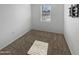 Simple bedroom with a window, wall-mounted TV bracket, and carpet at 30734 W Clarendon Ave, Buckeye, AZ 85396