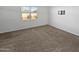 Bright bedroom with carpeted floor and window at 30734 W Clarendon Ave, Buckeye, AZ 85396