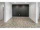 Open dining area with dark accent wall and tile floors at 30734 W Clarendon Ave, Buckeye, AZ 85396