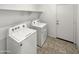 Laundry room with washer, dryer, and built-in shelving at 30734 W Clarendon Ave, Buckeye, AZ 85396