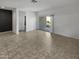 Bright living room with tile floors and sliding glass door to patio at 30734 W Clarendon Ave, Buckeye, AZ 85396