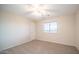 Bright bedroom with carpeted floor, ceiling fan, and window coverings at 30788 N Whirlaway Trl, San Tan Valley, AZ 85143