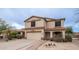 Two-story house with a beige exterior and a two-car garage at 30788 N Whirlaway Trl, San Tan Valley, AZ 85143