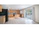 Kitchen with light wood cabinets, an island, and black appliances at 30788 N Whirlaway Trl, San Tan Valley, AZ 85143