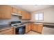 Kitchen area with light wood cabinets and a stovetop at 30788 N Whirlaway Trl, San Tan Valley, AZ 85143