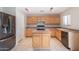 Kitchen with light wood cabinets and a black refrigerator at 30788 N Whirlaway Trl, San Tan Valley, AZ 85143