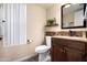 Updated bathroom with dark vanity and stone accent wall at 3247 E Silverwood Dr, Phoenix, AZ 85048