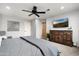 Main bedroom with ceiling fan, large window and dresser at 3247 E Silverwood Dr, Phoenix, AZ 85048