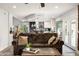 Open living space with a brown couch, coffee table, and a view into the kitchen at 3247 E Silverwood Dr, Phoenix, AZ 85048