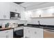 Modern kitchen with white cabinets and dark countertops at 351 E Thomas Rd # D208, Phoenix, AZ 85012