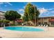 Community pool with surrounding lounge chairs at 351 E Thomas Rd # D208, Phoenix, AZ 85012