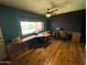 Spacious office with a large window, custom built-in desk, and wood flooring at 42213 N 3Rd St, Phoenix, AZ 85086