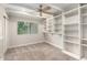 Bedroom with built in shelves, gray carpet, window with blinds, and ceiling fan at 4525 E Calle Ventura --, Phoenix, AZ 85018