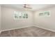 Cozy bedroom featuring neutral walls, gray carpet, and bright windows with white shutters at 4525 E Calle Ventura --, Phoenix, AZ 85018