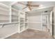 Bedroom featuring built-in shelving, gray carpet, and door to the hallway at 4525 E Calle Ventura --, Phoenix, AZ 85018