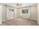 Bedroom featuring gray carpet, neutral walls, two windows, and a ceiling fan at 4525 E Calle Ventura --, Phoenix, AZ 85018