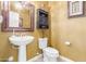 Elegant bathroom with pedestal sink and decorative mirror at 4547 E Sodalite St, San Tan Valley, AZ 85143