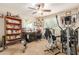 Home office features built-in shelving, a desk, and exercise equipment at 4547 E Sodalite St, San Tan Valley, AZ 85143