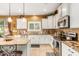 Kitchen features granite countertops, white cabinets, and stainless steel appliances at 4547 E Sodalite St, San Tan Valley, AZ 85143