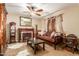 Cozy living room with fireplace and leather sofa at 4547 E Sodalite St, San Tan Valley, AZ 85143