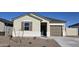 Single-story house with neutral siding, brown garage door, and small front yard at 5484 E Rock Bush Ln, San Tan Valley, AZ 85140