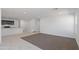 Open living room and kitchen with gray carpet, tile, and kitchen island at 5484 E Rock Bush Ln, San Tan Valley, AZ 85140