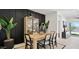 Modern dining room features wood table, rattan chairs, and black accent wall at 5596 E Arctic Ln, San Tan Valley, AZ 85140