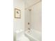 Bathroom features a combined shower and tub with decorative gold hardware and neutral color tiles at 6137 E Roland St, Mesa, AZ 85215