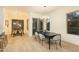 Bright dining room with contemporary chandelier, light wood floors, and a sliding glass door to the exterior at 6137 E Roland St, Mesa, AZ 85215