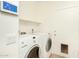 Functional laundry room with washer, dryer, shelving and a dog door at 6137 E Roland St, Mesa, AZ 85215