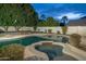 Beautiful backyard pool and spa with lush greenery and privacy fencing at 6137 E Roland St, Mesa, AZ 85215